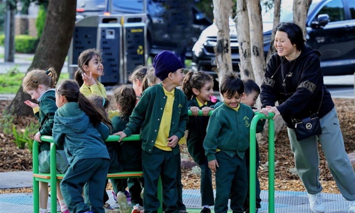 Children playing on an inclusive spinner