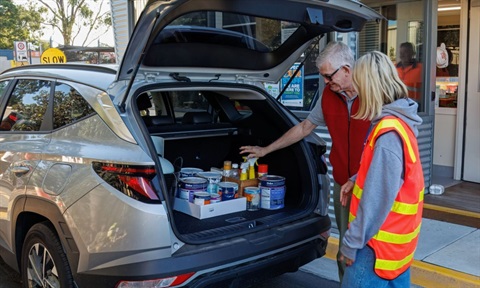 Man showing car boot with paint tins at the Monash Recycling and Waste Centre
