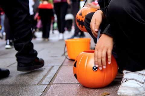 halloween buckets and costumes on city street