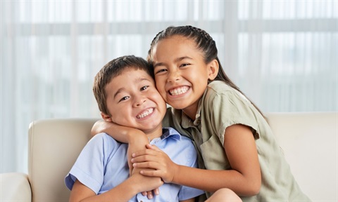 Brother and sister hugging