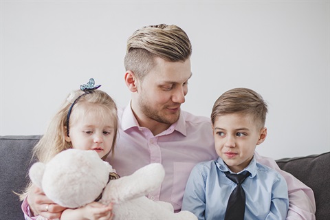 Father sitting with his two children