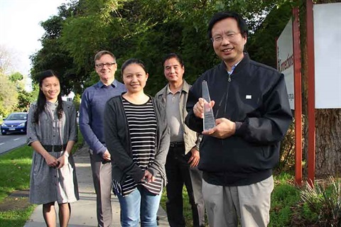 Joseph Jin holding award