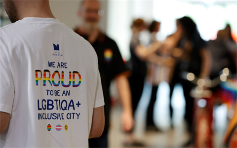 A close up of the back of a white t-shirt that reads 