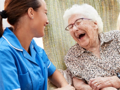 Young support worker talking to older person