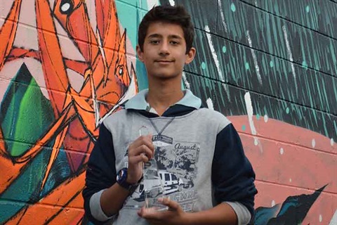 Prateek Pillai holding award