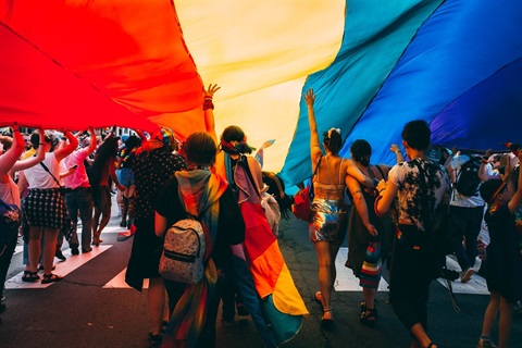 youth under pride flag