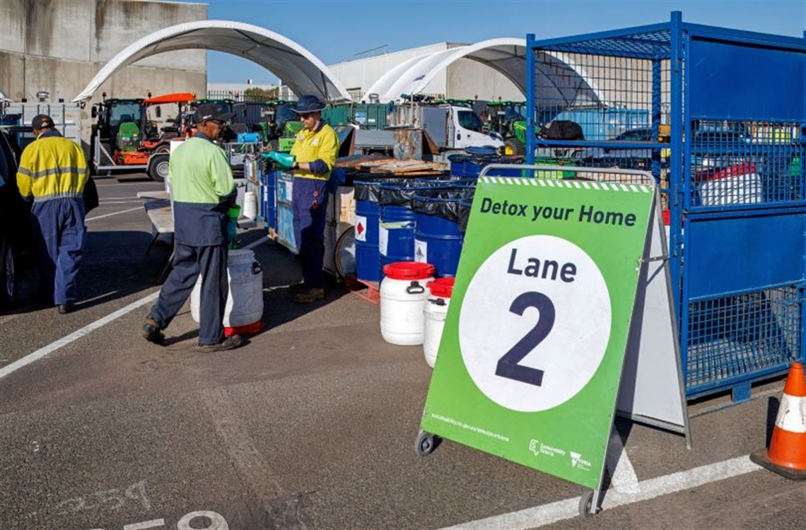 A safe outdoor hazardous waste collection point with a green 
