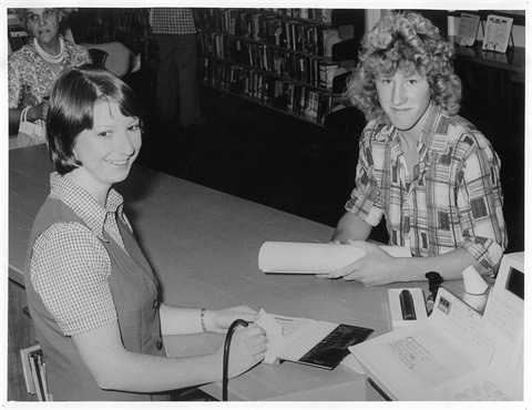 1976-Staff-member-Chris-Clarke-issuing-books-to-a-customer-using-the-new-light-wand-system-Glen-Waverley-library-1976