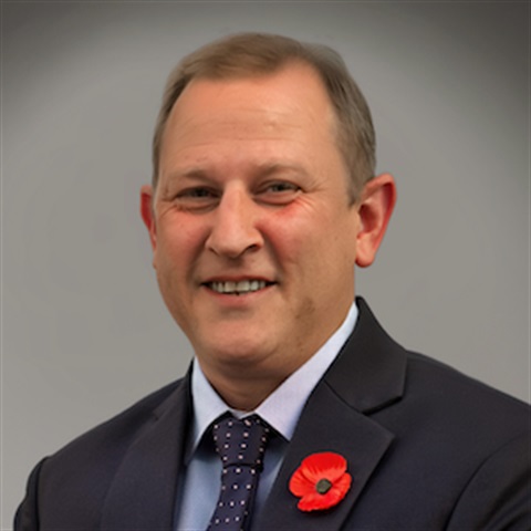 Portrait of Mayor Stuart James wearing a poppy for Remembrance Day.