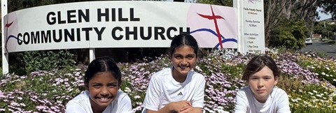 Aneel, Rei and Thesara sitting in front of Glen Hill Community Church