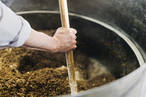 Worker mixing potting mix