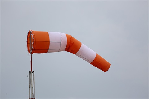 wind sock in the wind with white sky